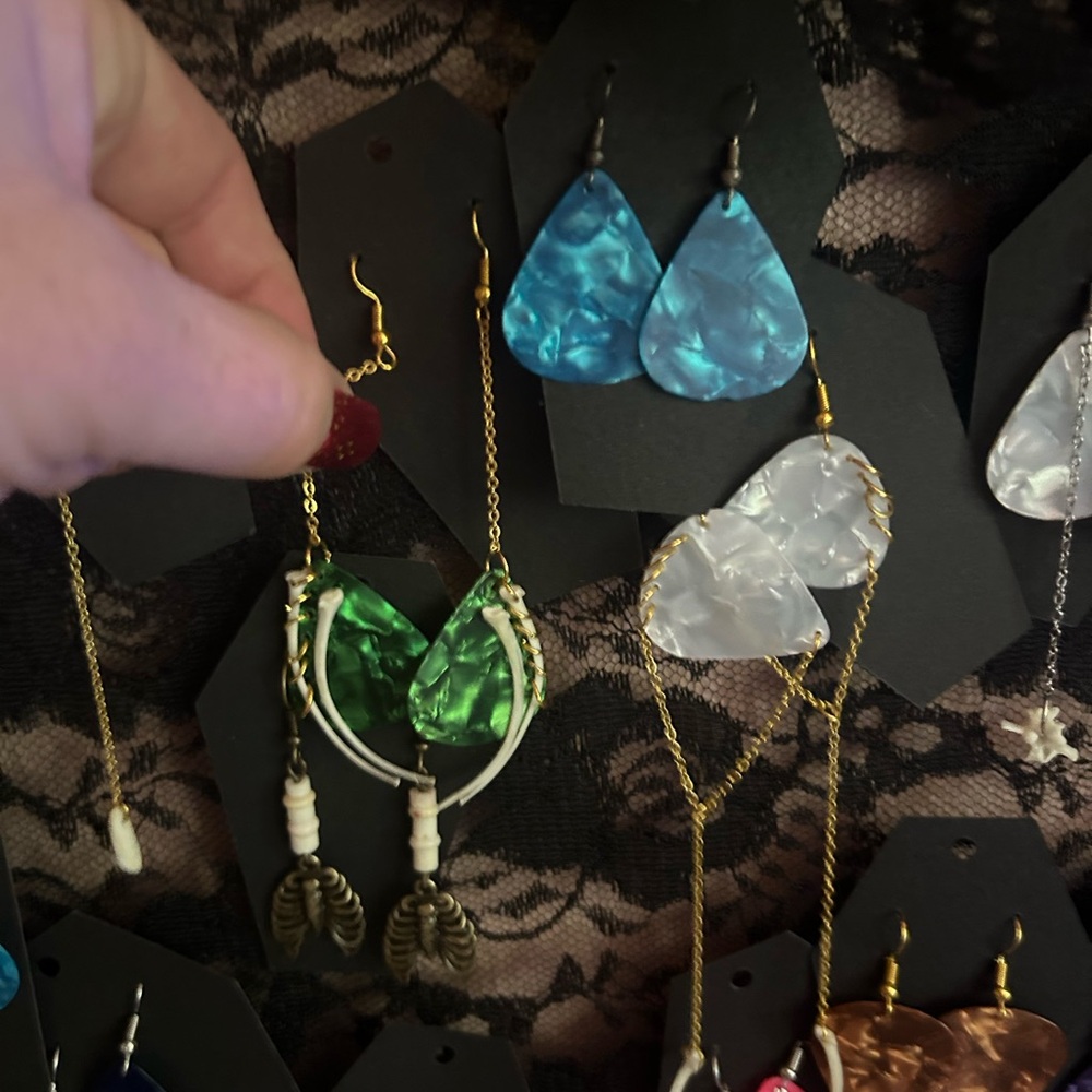Hand made earrings, snake bones and guitar pics.